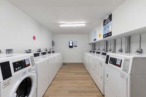 A row of washing machines in a laundromat.