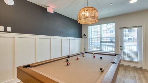 A pool table with balls set up in a rack.