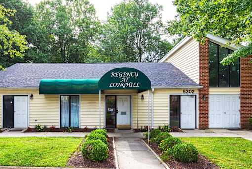 A building with a green awning and a sign that says