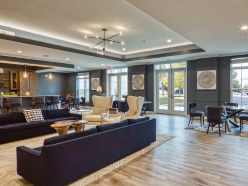a living room with couches and chairs and a table and chairs in a lobby