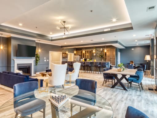 a living room with couches tables and chairs and a fireplace