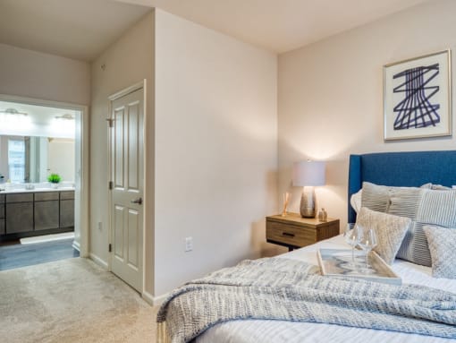 a bedroom with a bed and a bathroom with a sink