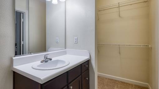 A bathroom with a sink and mirror.