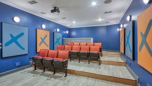 A room with blue walls and orange chairs.