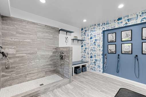 A bathroom with a walk-in shower and a towel rack.