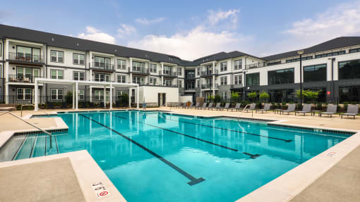 a swimming pool with apartment buildings in the background at Ainsworth, Richmond