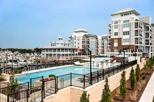 A large building with a pool in front of it.