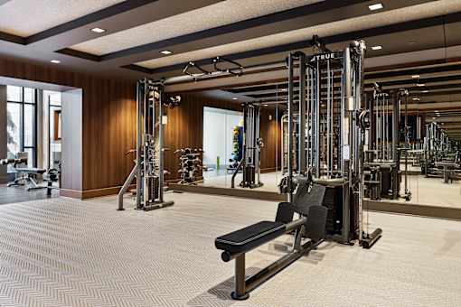 a gym with weights machines and a bench