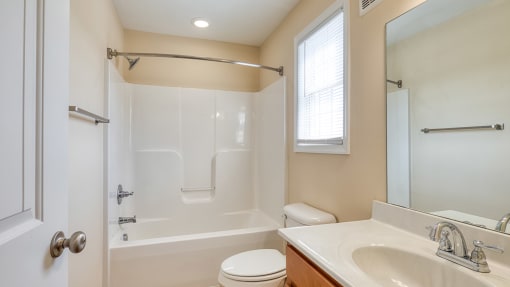 a bathroom with a shower toilet and sink and a mirror