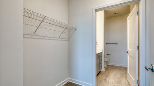 an empty bathroom with a closet and a toilet at The Port at East Beach Apartments and Marina, Virginia, 23518
