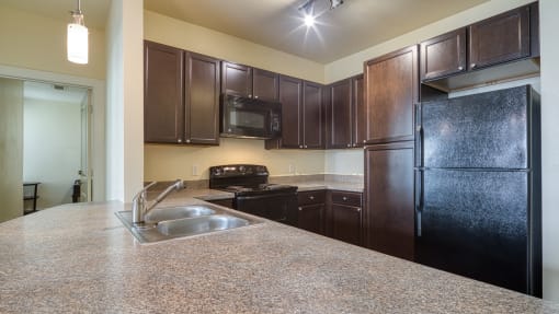 a kitchen with black appliances and granite counter tops at Proximity at ODU, Virginia, 23508