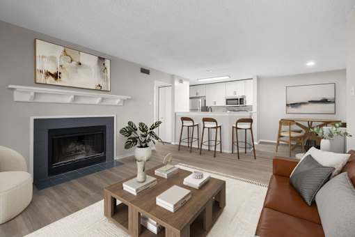 A modern living room with a fireplace and a coffee table.