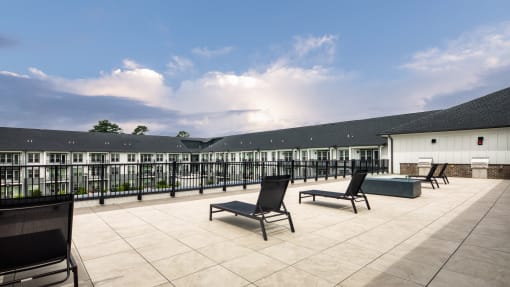 a terrace with chairs and tables and a building in the background at Ainsworth, Richmond, Virginia
