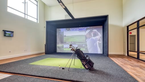 a golf bag on a tripod in front of a screen in a room with a at Ainsworth, Richmond, Virginia