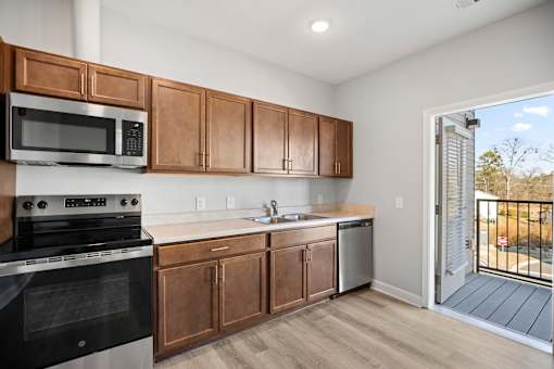 A kitchen with wooden cabinets and a black oven.