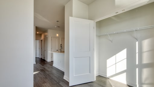 an empty living room with white walls and a white door at The Port at East Beach Apartments and Marina, Norkfolk, 23518