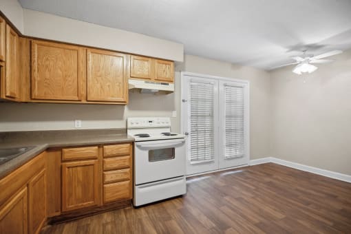 the preserve at ballantyne commons apartment kitchen with white appliances and wooden cabinets