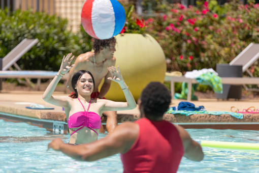 women playing volley in a swimming pool at Proximity at ODU in Norfolk, VA 23508