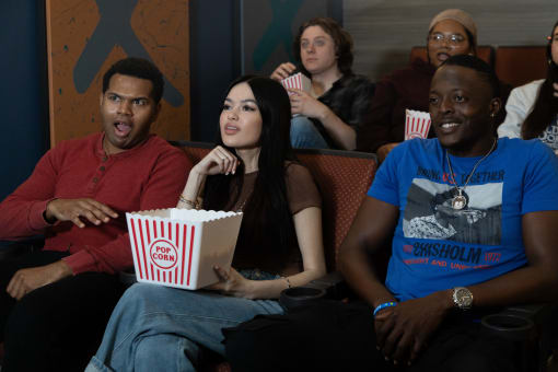 a group of people sitting in a movie theater eating popcorn at Proximity at ODU in VA 23508