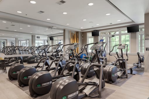 a gym filled with cardio machines and weights
