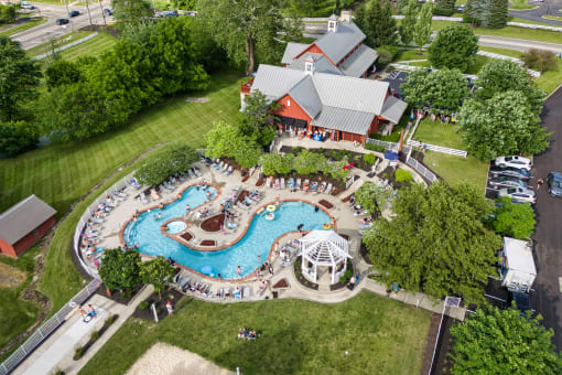 an overhead view of a resort style swimming pool with a pavilion