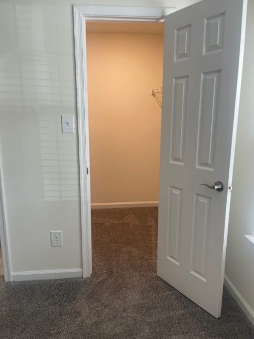 a room with a closet and a door open to a bathroom