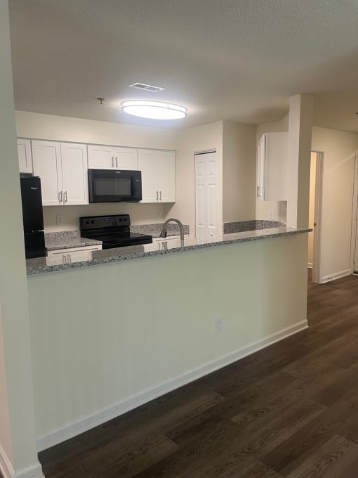 a view of a kitchen with a counter top and a microwave