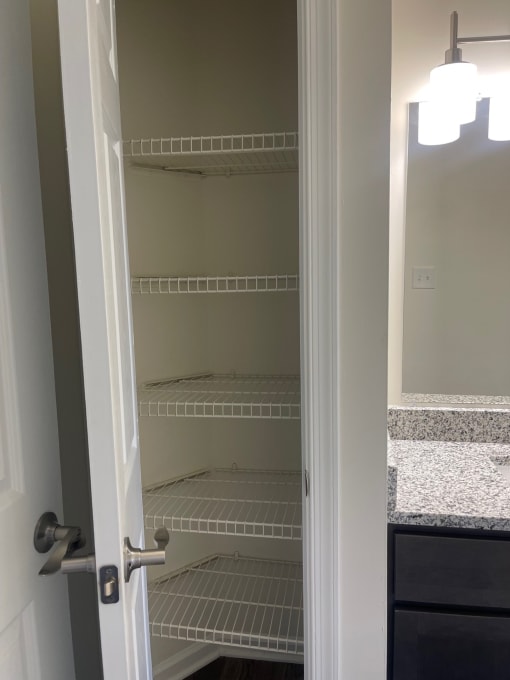 a closet with empty shelves in a bathroom