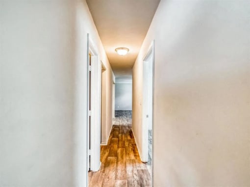 a long hallway with doors and a lamp on the ceiling at Gates of West Bay, Norfolk, VA