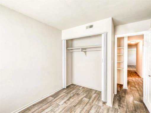 an empty bedroom with a closet and a mirrored closet door at Gates of West Bay, Norfolk, VA