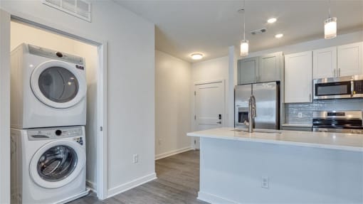 a laundry room with a washer and dryer and a kitchen at The Port at East Beach Apartments and Marina, Norkfolk