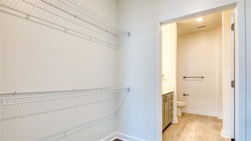 a white bathroom with a toilet and a closet at The Port at East Beach Apartments and Marina, Norkfolk, VA, 23518