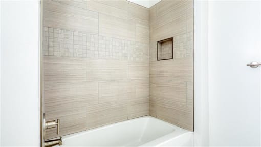 a bathroom with a bath tub and a shower at The Port at East Beach Apartments and Marina, Virginia, 23518