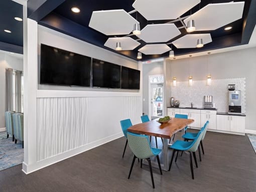a conference room with a wooden table and blue chairs at Addison Crater Woods, Petersburg, VA