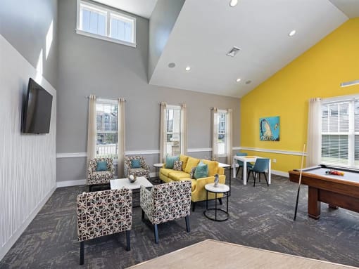 a living room with couches and chairs and a pool table at Addison Crater Woods, Virginia, 23805