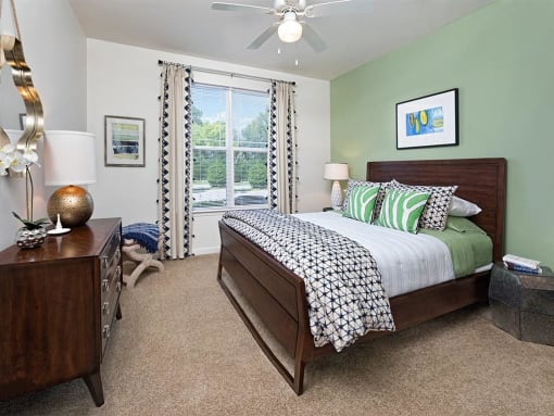 a bedroom with a bed and a ceiling fan at Addison Crater Woods, Petersburg