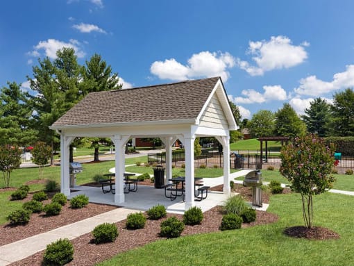 a pavilion with picnic tables in a park at Addison Crater Woods, Petersburg