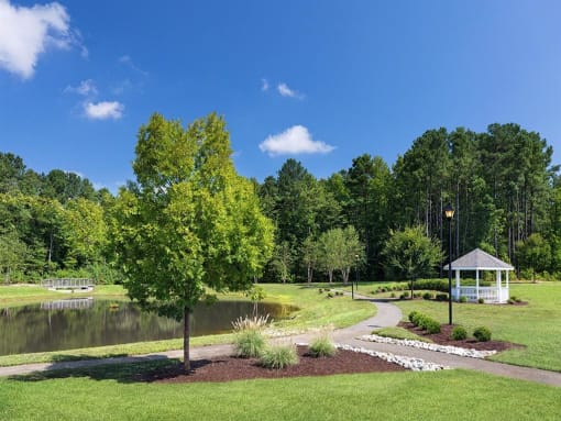 a park with a pond and gazebo at Addison Crater Woods, Virginia