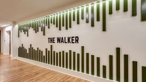 A wall with bars and the words "The Walker" on it.