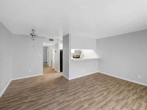 A room with wooden flooring and white walls.