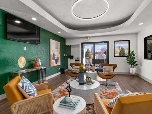 A living room with a green wall and a television.
