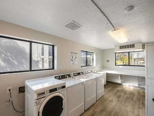 A laundry room with a washer and dryer stacked on top of each other.