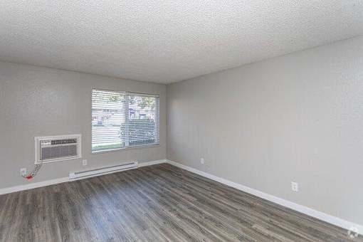 A room with a window and a fireplace.