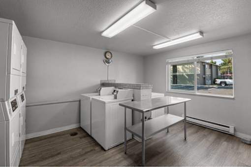A white kitchen with a window and a sink.