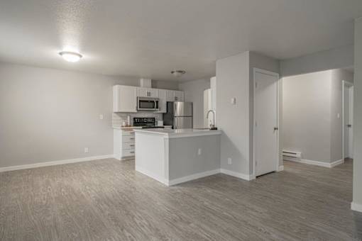 A kitchen with white cabinets and a microwave above the stove.