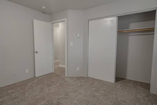A room with a carpeted floor and white walls.