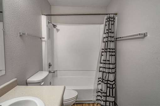A white toilet sits next to a sink in a small bathroom.