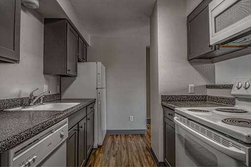 A kitchen with a stove, oven, and refrigerator.