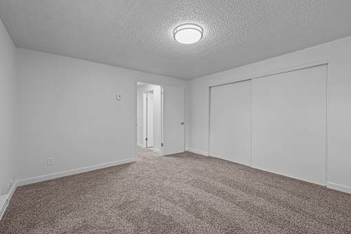 A room with a carpeted floor and a ceiling light.