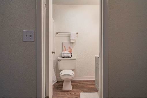 A white toilet in a small bathroom.